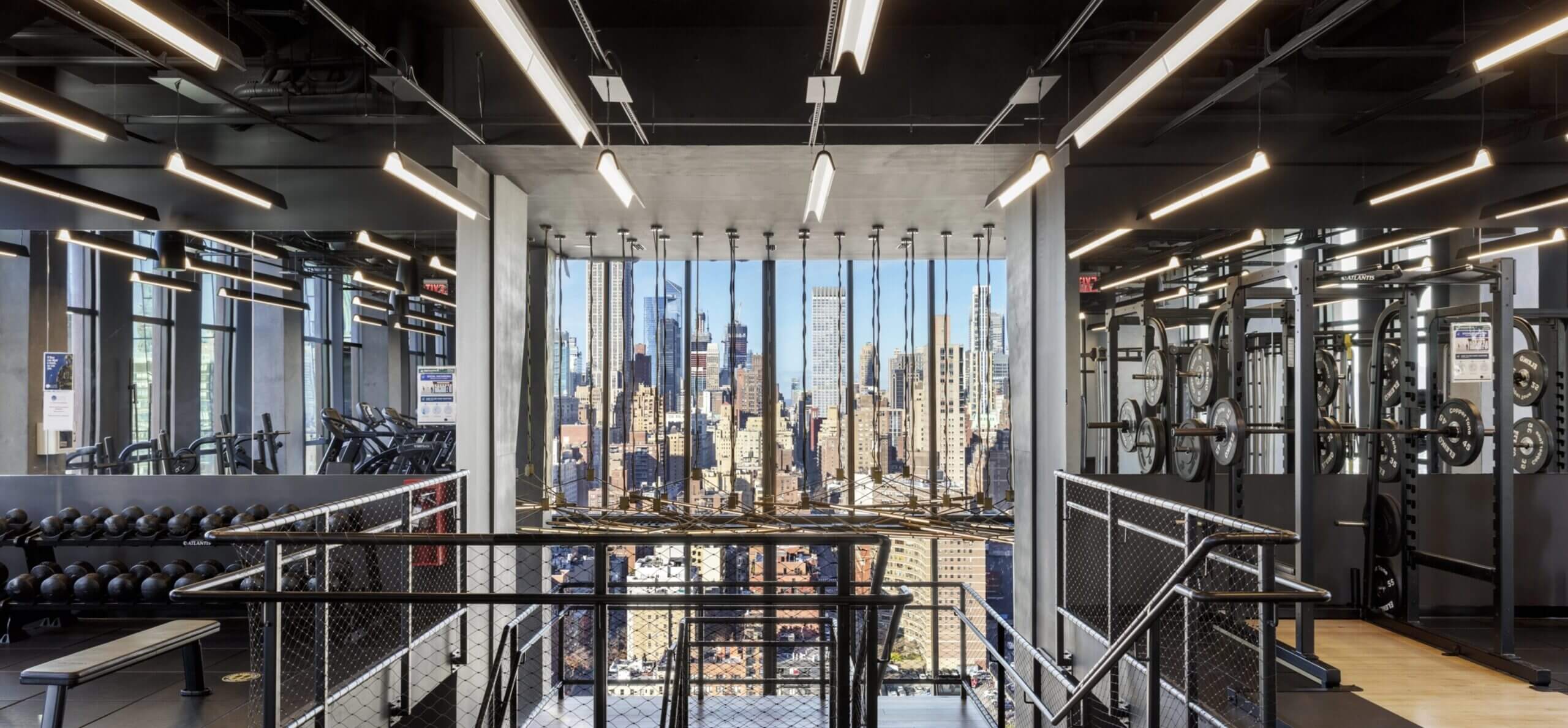 Fully equipped gym with views of the Manhattan skyline located at the Copper, apartments for rent in Murray hill