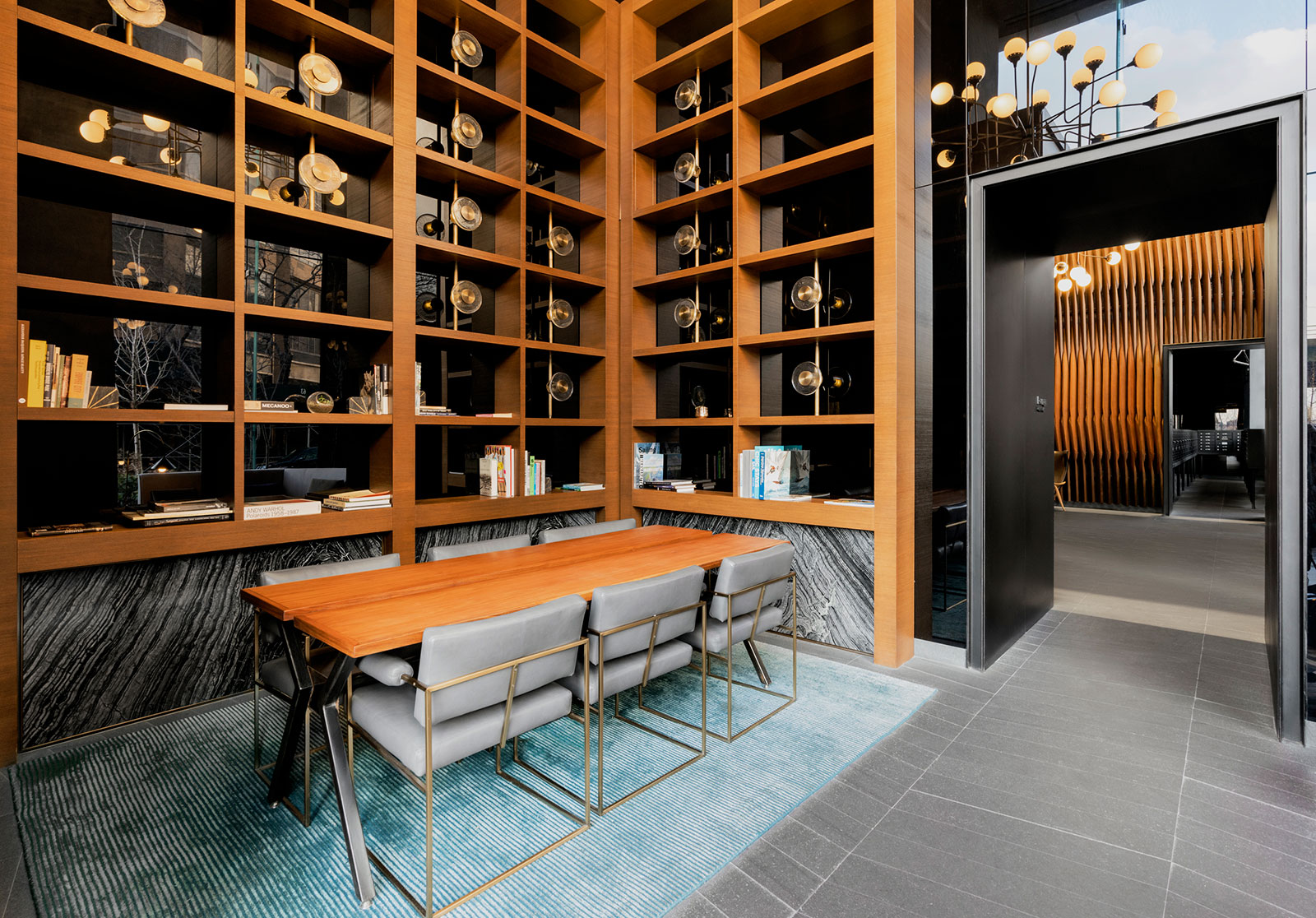 Modern library amenity with seating at The Copper apartments in Murray Hill, offering residents a quiet reading space
