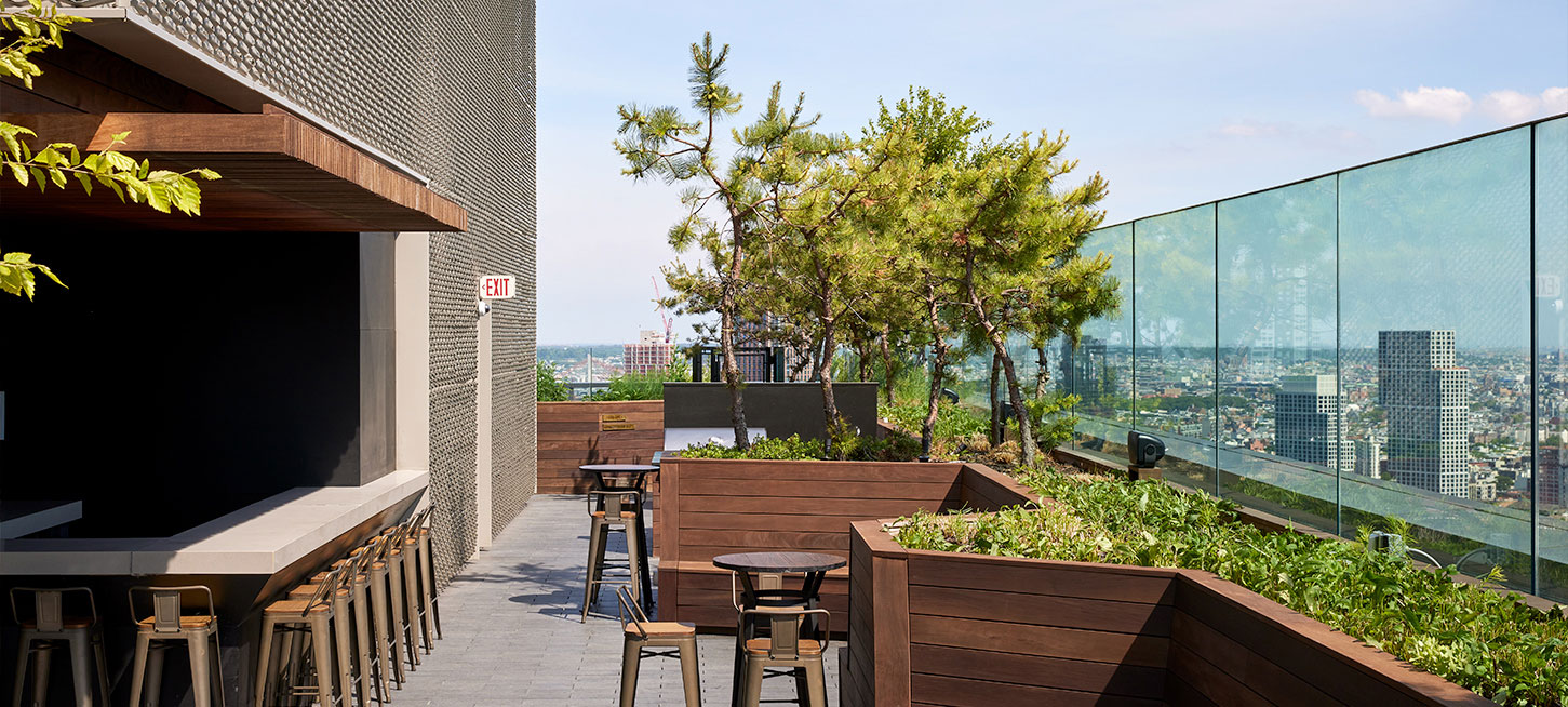 Beautiful rooftop lounge at The Copper apartments in NYC, featuring comfortable seating and stunning city skyline views.