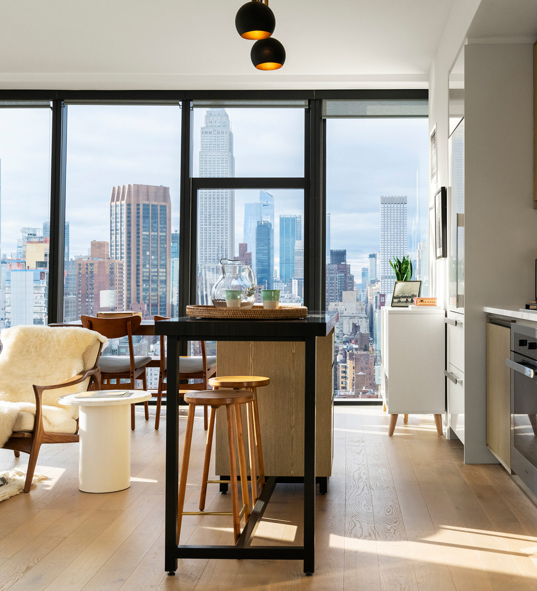 Luxury living room at The Copper in Murray Hill featuring hardwood floors, natural light, and stunning Manhattan views.