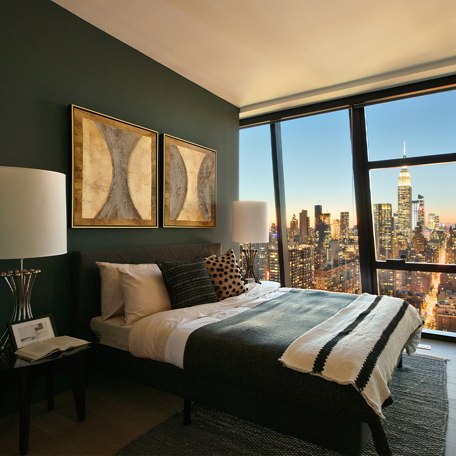 Modern and cozy bedroom at The Copper in Murray Hill, featuring floor-to-ceiling windows with perfect city views.