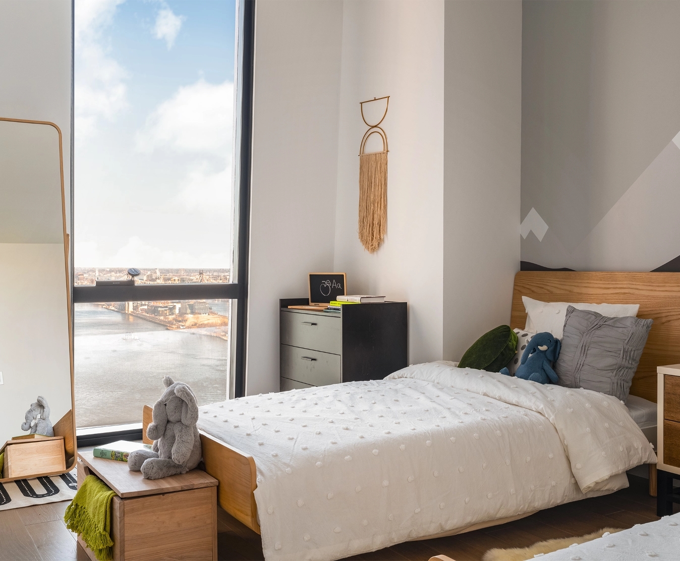 Cozy children’s bedroom at The Copper apartments in NYC, designed with bright colors and fun features for little residents.