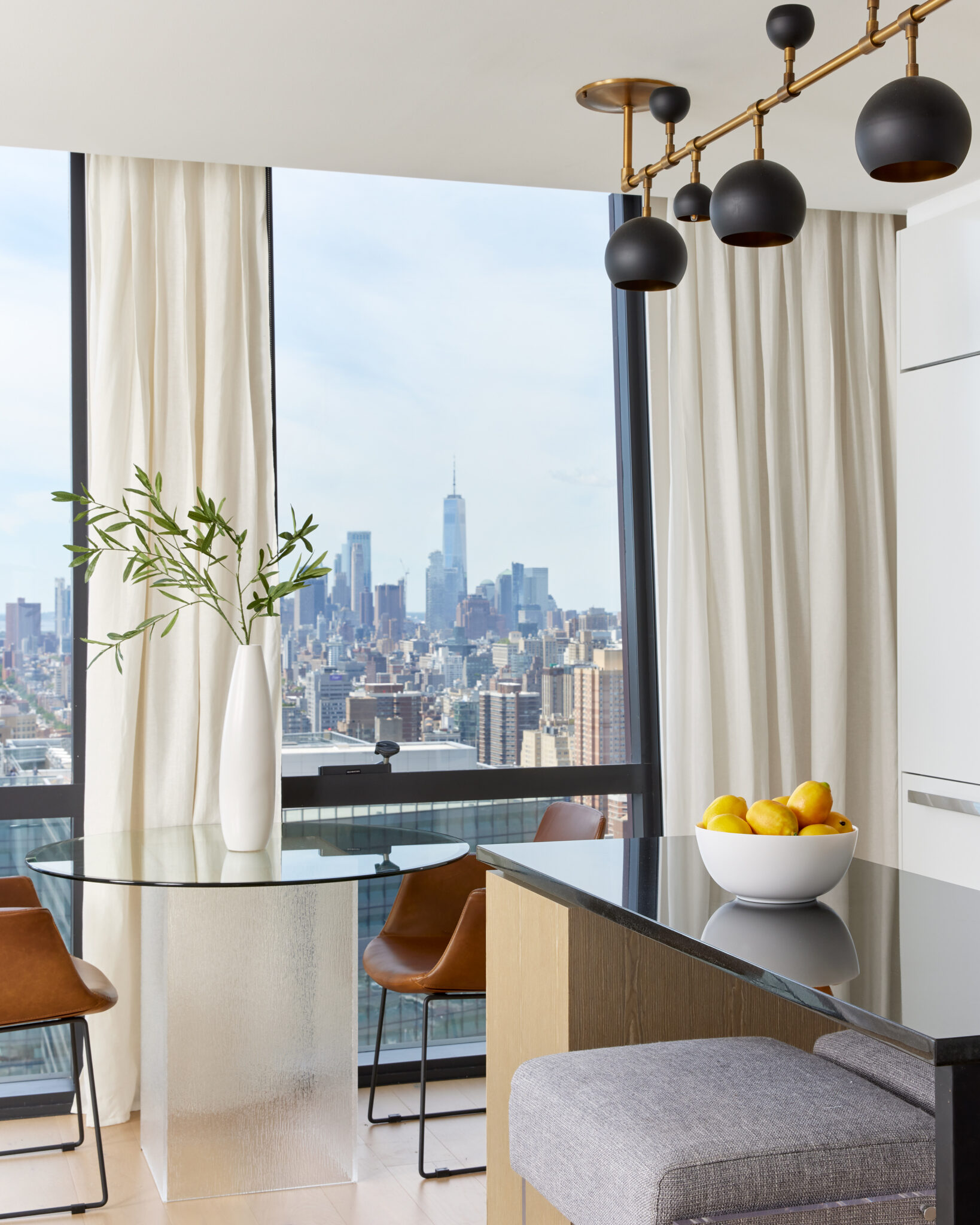 Spacious dining area at The Copper apartments for rent in Murray Hill with seating and stunning views of Manhattan.