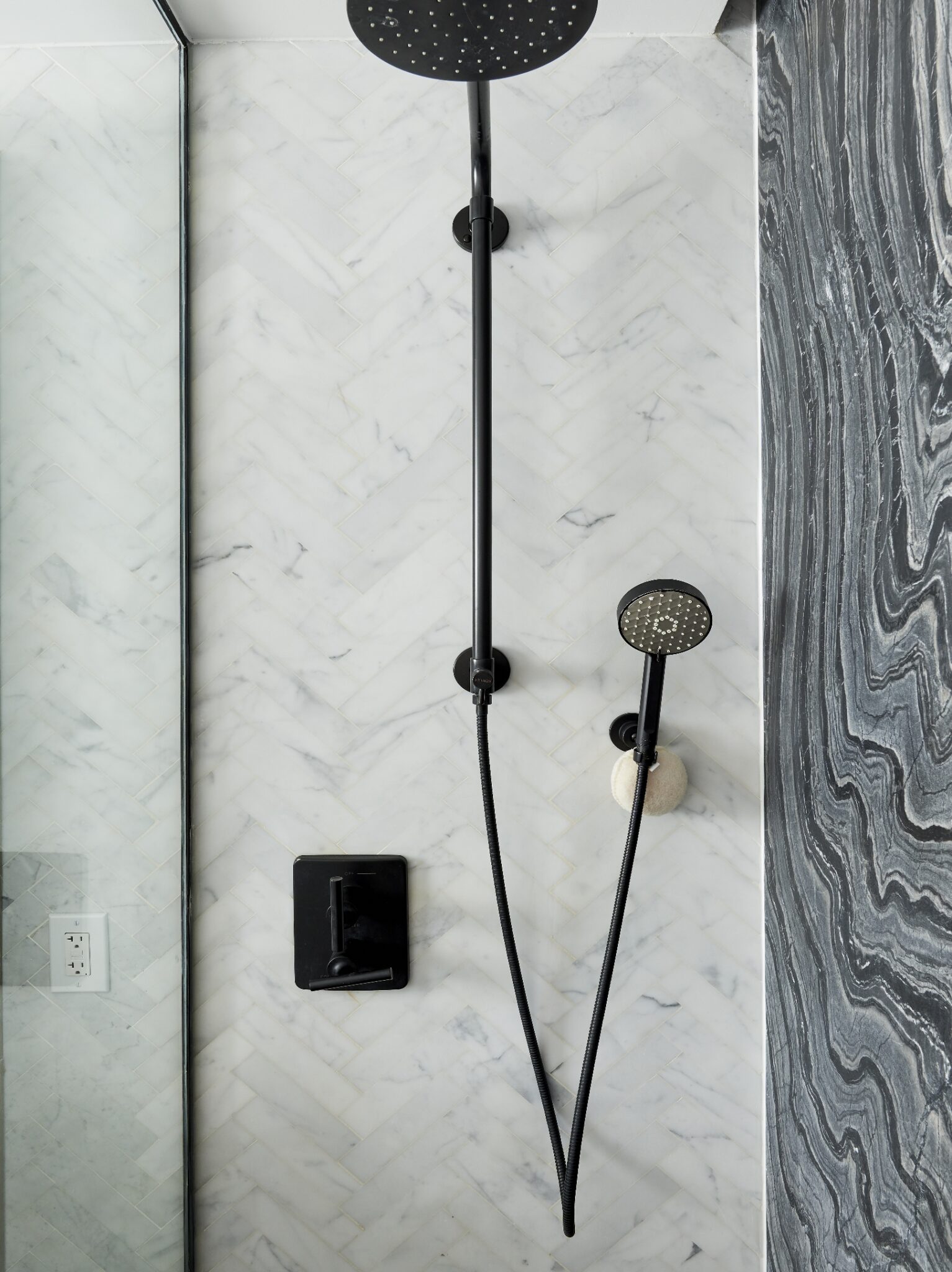 Beautiful rain shower with detachable handheld spray and marble wall at The Copper apartments in Murray Hill.